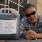 man next to a 5-Fe solution