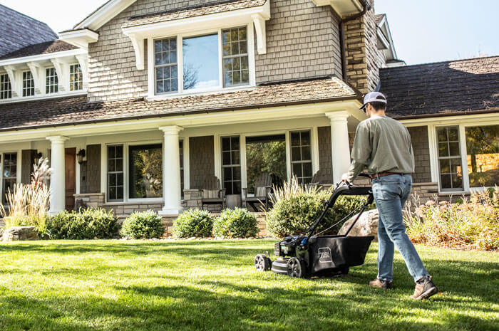 Man mowing his front yard