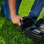 man sets mower height on lawn mower