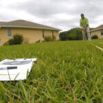 Man measuring the yard with a tape measure