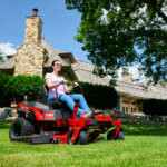 woman using Toro TimeCutter Max in her front yard