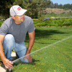 Man re-positioning the Sprinkler