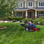 Woman using Toro Timecutter Z Seed Spreader in front yard