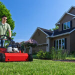 Man using Toro Hydraulic Aerator in front yard