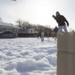 People playing in a snowy yard