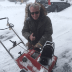 Man giving a thumbs up posing with his Toro CCR 2000 snowblower surrounded by snow