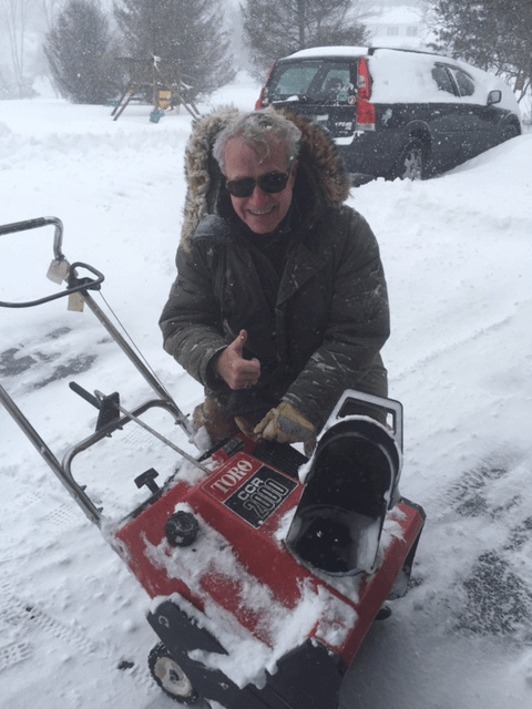 Man giving a thumbs up posing with his Toro CCR 2000 snowblower surrounded by snow