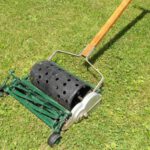 Old model of Toro push mower with green blades