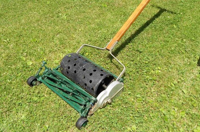 Old model of Toro push mower with green blades