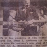 An old newspaper photo of two children cutting a ribbon to open a new Toro plant location with Gov. Elmer L Andersen assisting them