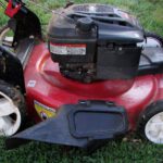 Close up of Toro lawnmower in green yard