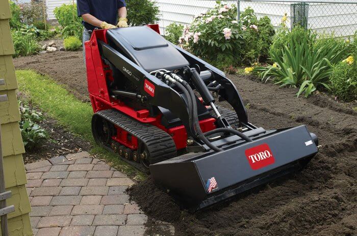 Toro Dingo digging up dirt in front yard