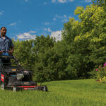 Man focusing on mowing lawn