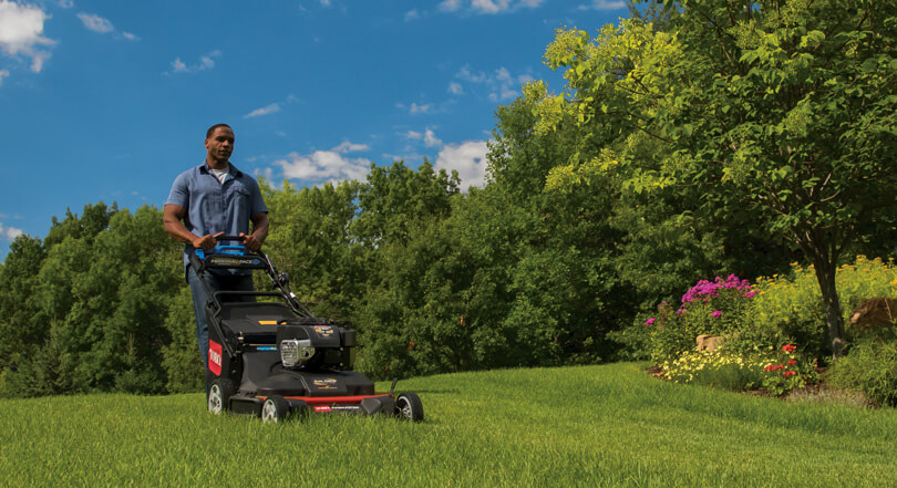 Man focusing on mowing lawn