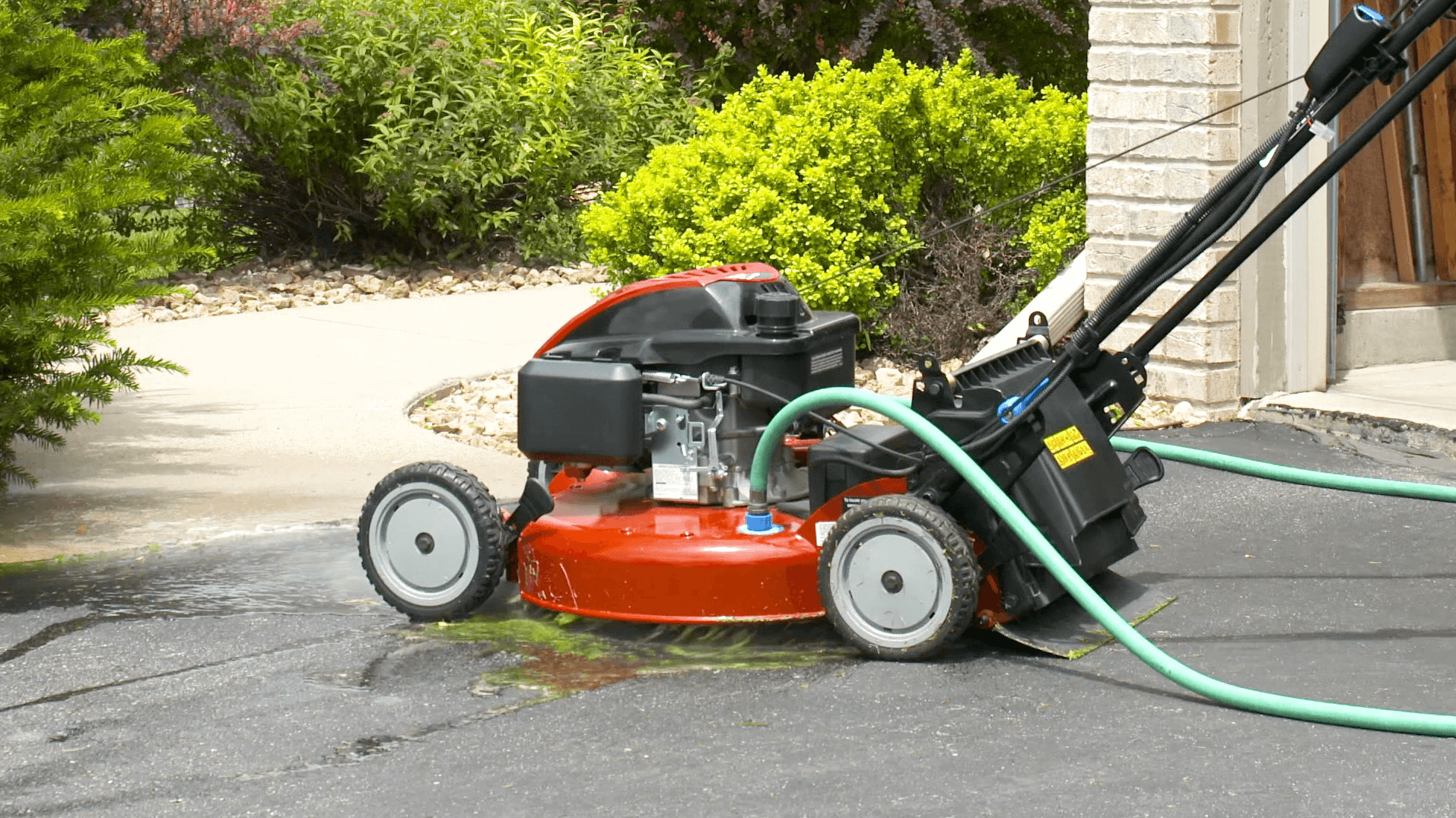 Lawnmower with hose plugged into it's deck
