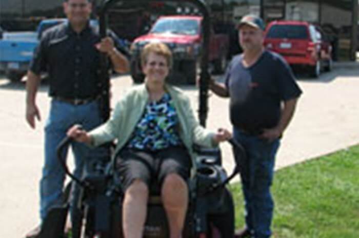 Winner of Spring Fever Toro Giveaway posing with riding mower