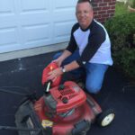 Man filling Toro gas tank in his driveway