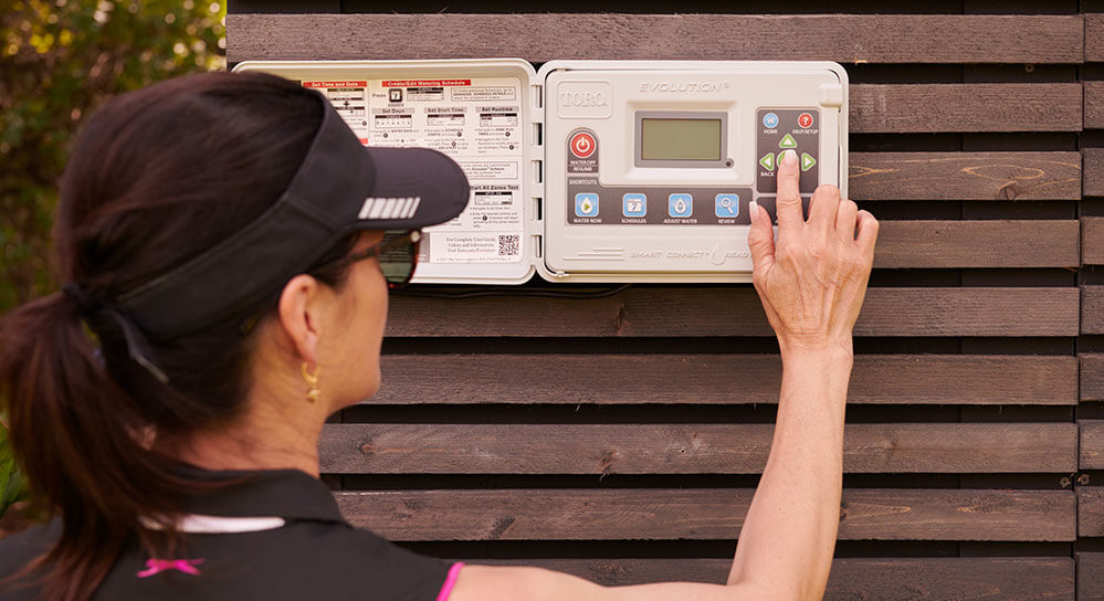 Women programming the irrigation control panel