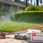 Yard with tools and equipment on the curb ready for an irrigation project