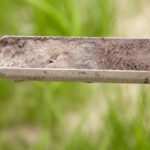 Close up of soil on blade of grass