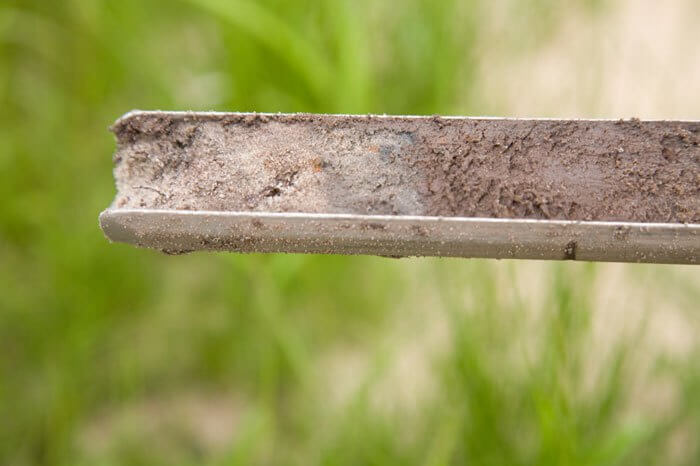 Close up of soil on blade of grass