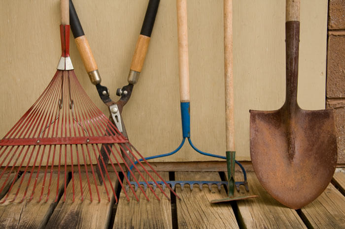 Yard tools leaning against wall