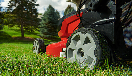 close up of a rear wheel of a lawn mower