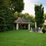 A backyard with a gazebo and patio area