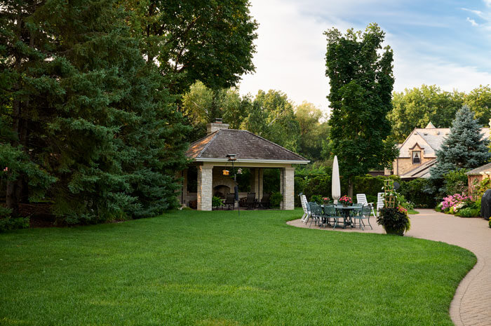 A backyard with a gazebo and patio area